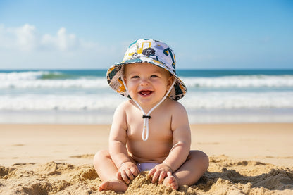 bebe portant chapeau anti UV bebe motif tracteur a plage
