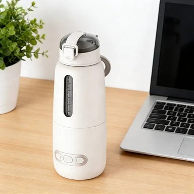 chauffe biberon portable sur table près ordinateur